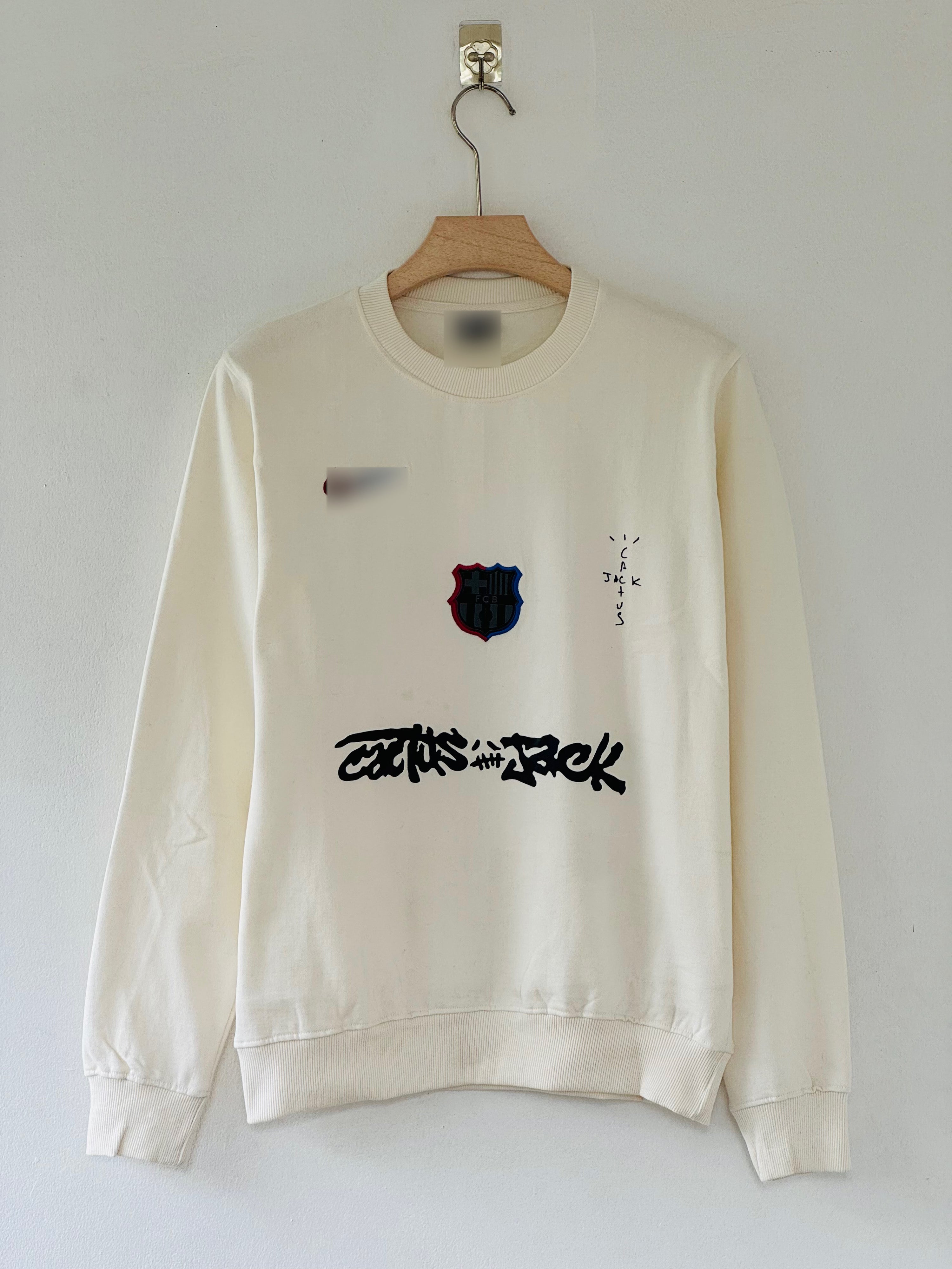 cream-colored FC Barcelona x Cactus Jack sweatshirt