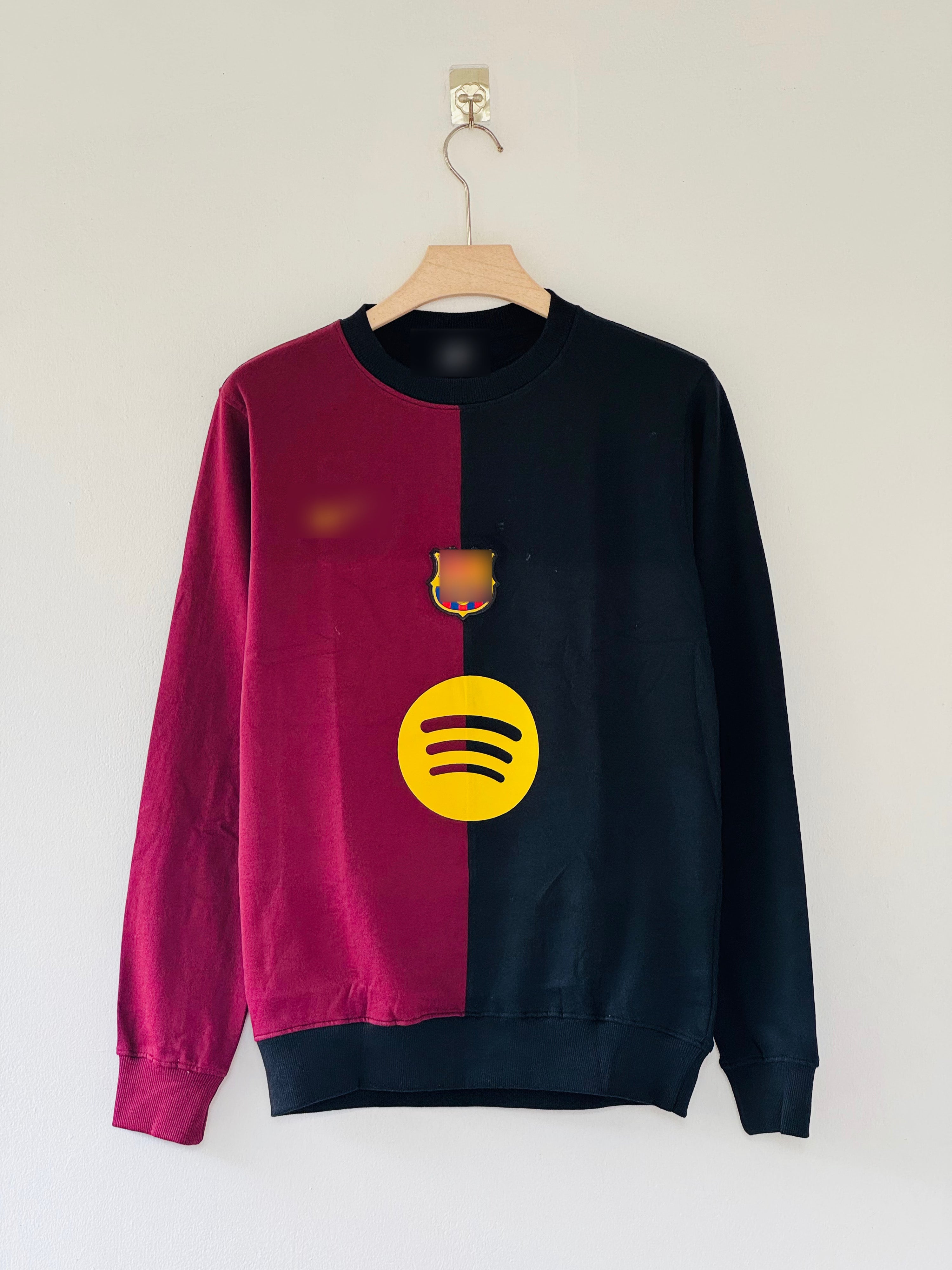 Barcelona FC crew-neck sweatshirt features a distinct split design in maroon and black